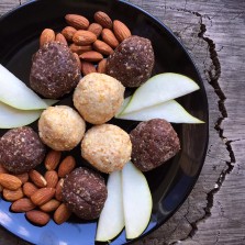 Cashew & Apricot Protein Balls with almonds & pear slices on a serving plate